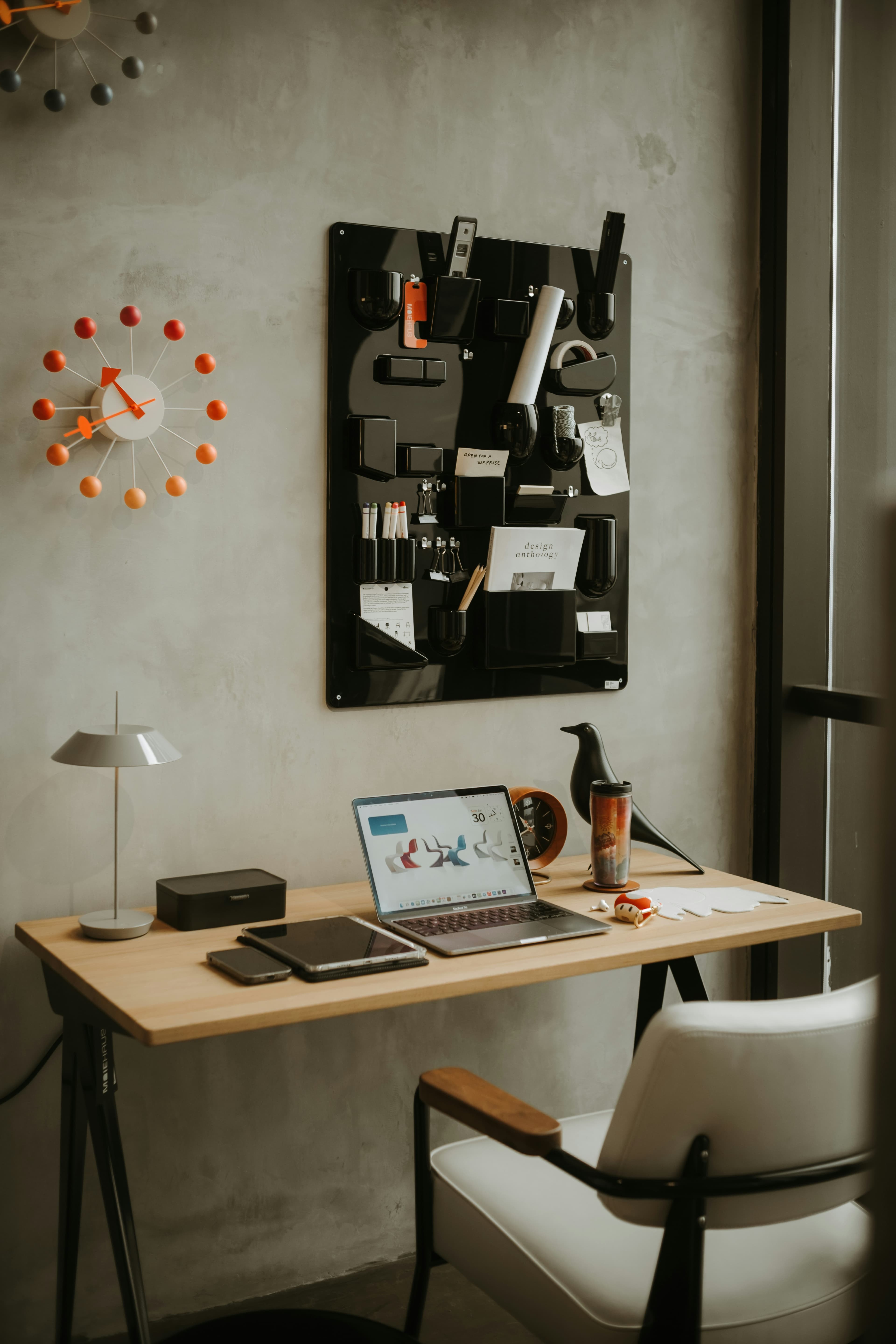 Organized creative workspace with laptop and planning board